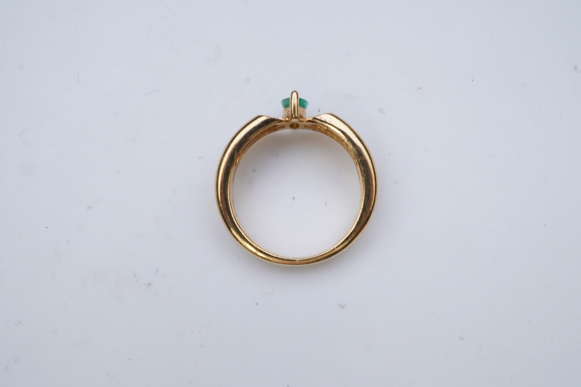 An emerald and diamond ring